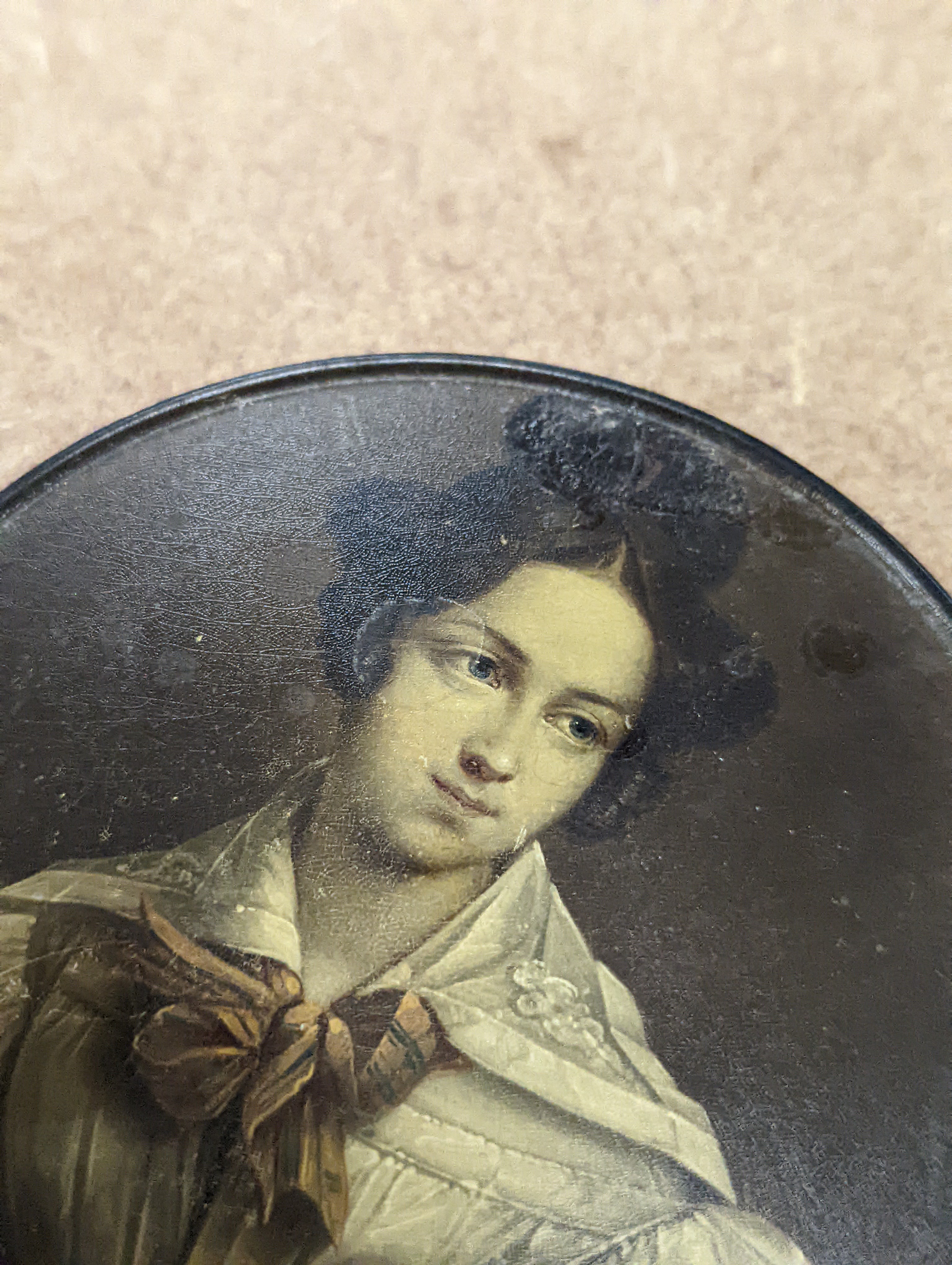 A 19th century Stobwasser papier mache ‘Henriette Sonntag’ portrait snuff box, c.1830, 9.7cm diameter and a 19th-century papier mache snuff box painted with a portrait of a German hussar, 9.4cm (2)